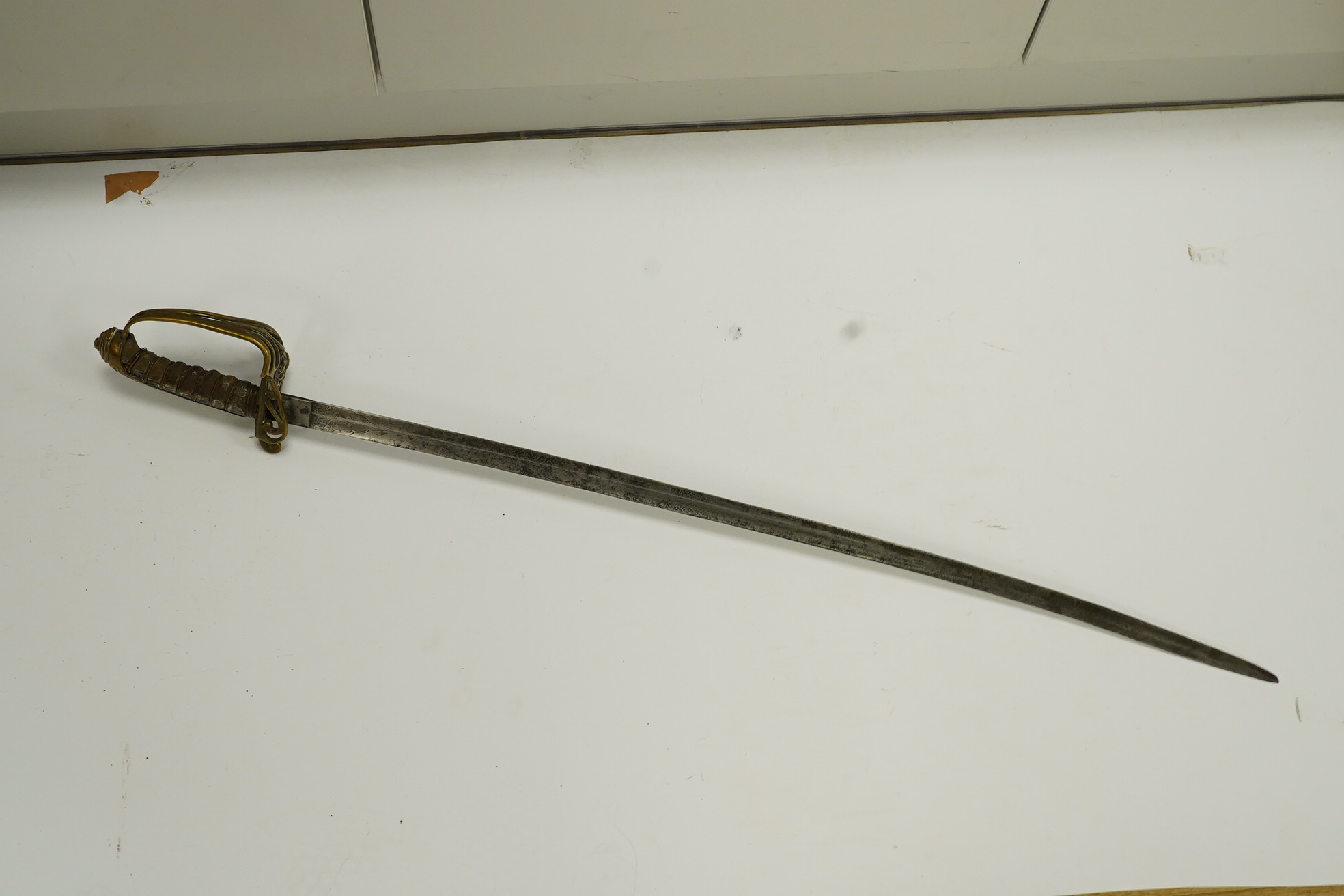 A Victorian 1845 pattern infantry officer’s sword, with regulation blade and brass hilt with folding side guard. Condition - fair, well worn over all.